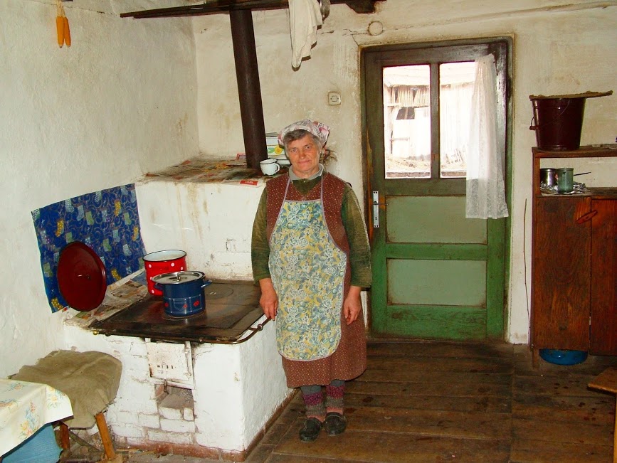 Local woman preparing lunch in her home. Dobra river. 
